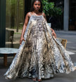 Sleeveless maxi dress with tropical leaf print, flowing A-line silhouette