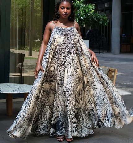 Sleeveless maxi dress with tropical leaf print, cream base and dark foliage