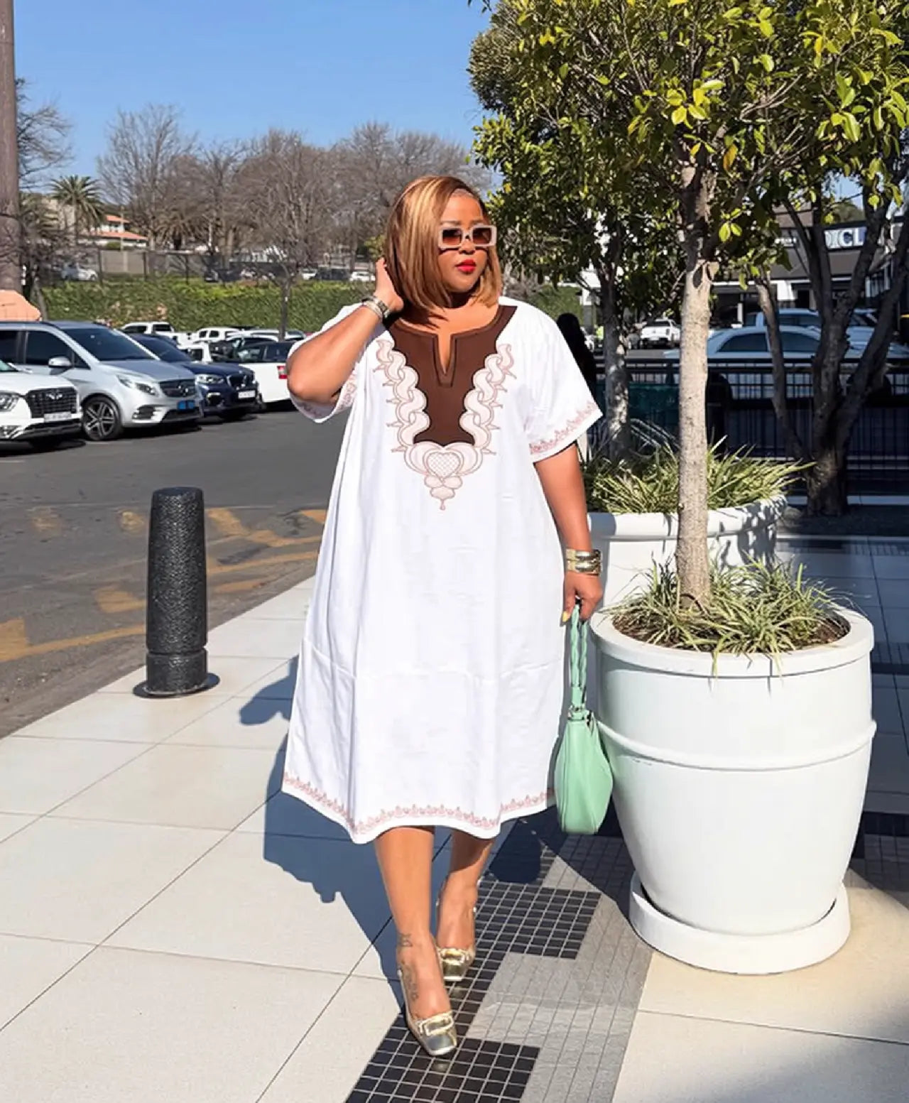 White loose kaftan dress with embroidered V neckline and mid-length hem
