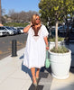 White loose kaftan dress with embroidered V neckline and mid-length hem