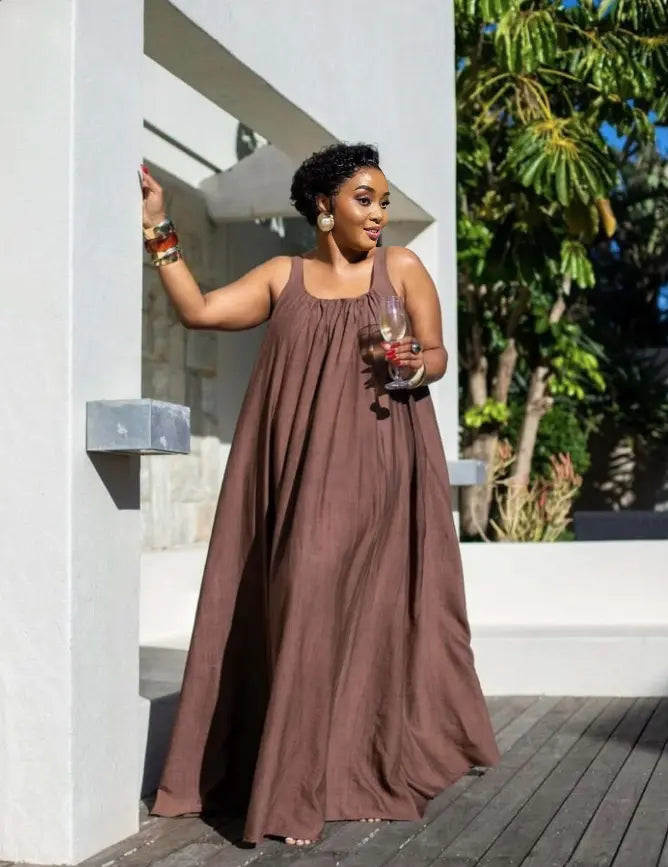 Brown sleeveless maxi dress with gathered bodice and flowing skirt