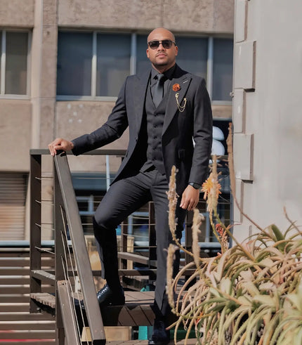 Men's black three-piece suit with shawl lapel jacket, vest, and slim-fit trousers