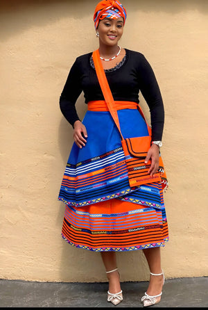 Layered geometric stripe skirt in blue and orange with wide tiered hem.