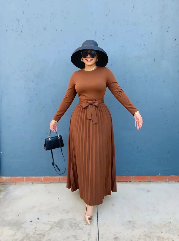 Women knit maxi dress in rust-brown with crew neck, long sleeves, pleated skirt, tie waist