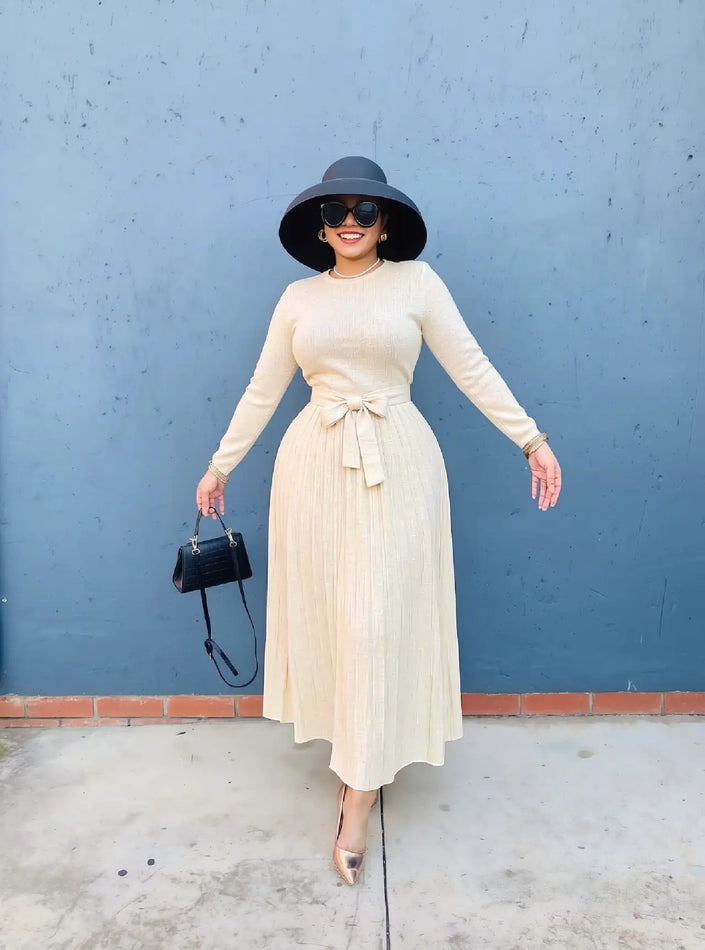 Women knit maxi dress in cream, crew neck, long sleeves, pleated skirt, waist tie