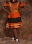 Orange and black polka dot puff-sleeve midi dress with tiered skirt