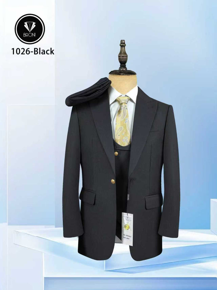 Black peak-lapel suit jacket on mannequin, gold buttons and flap pockets