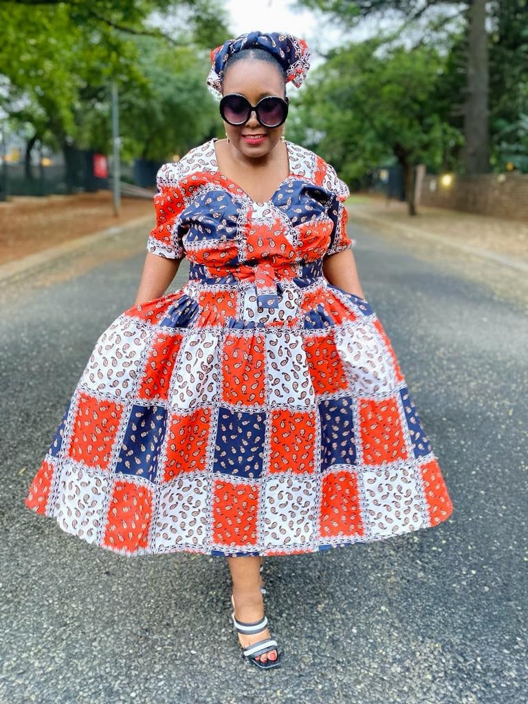 Geometric midi dress with puff sleeves, patchwork squares in red, blue, and white