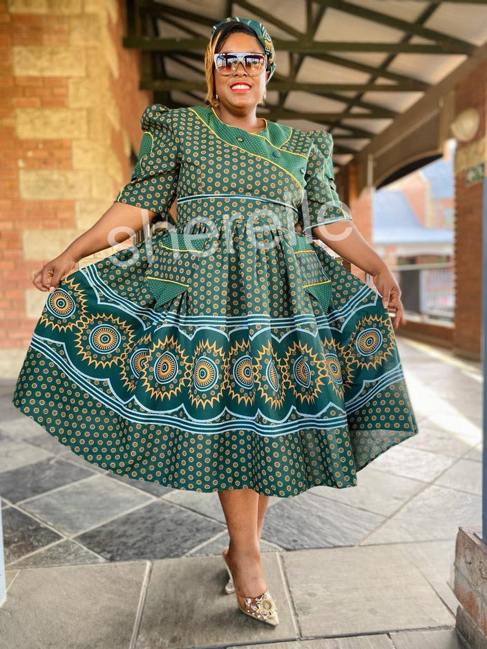 Dark green A-line midi dress with puff sleeves, tiered skirt, medallion geometric pattern