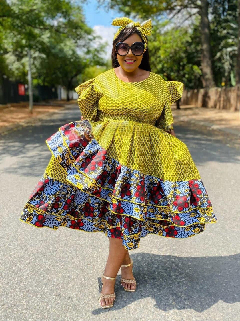Yellow African print midi dress with ruffled puff sleeves and tiered skirt