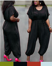 Black cinched-waist jumpsuit with drawstring and loose wide legs at ankle cuffs