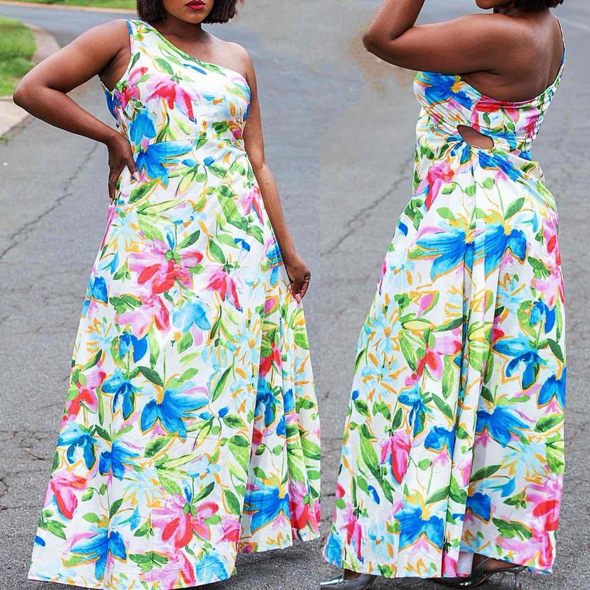 One-shoulder floral maxi dress with flared skirt, sleeveless one-strap, white base.