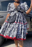 Geometric midi dress with puff sleeves, black-and-white pattern, red trim hem