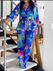 Printed blouse and trousers set with vivid geometric multicolor pattern, blue base