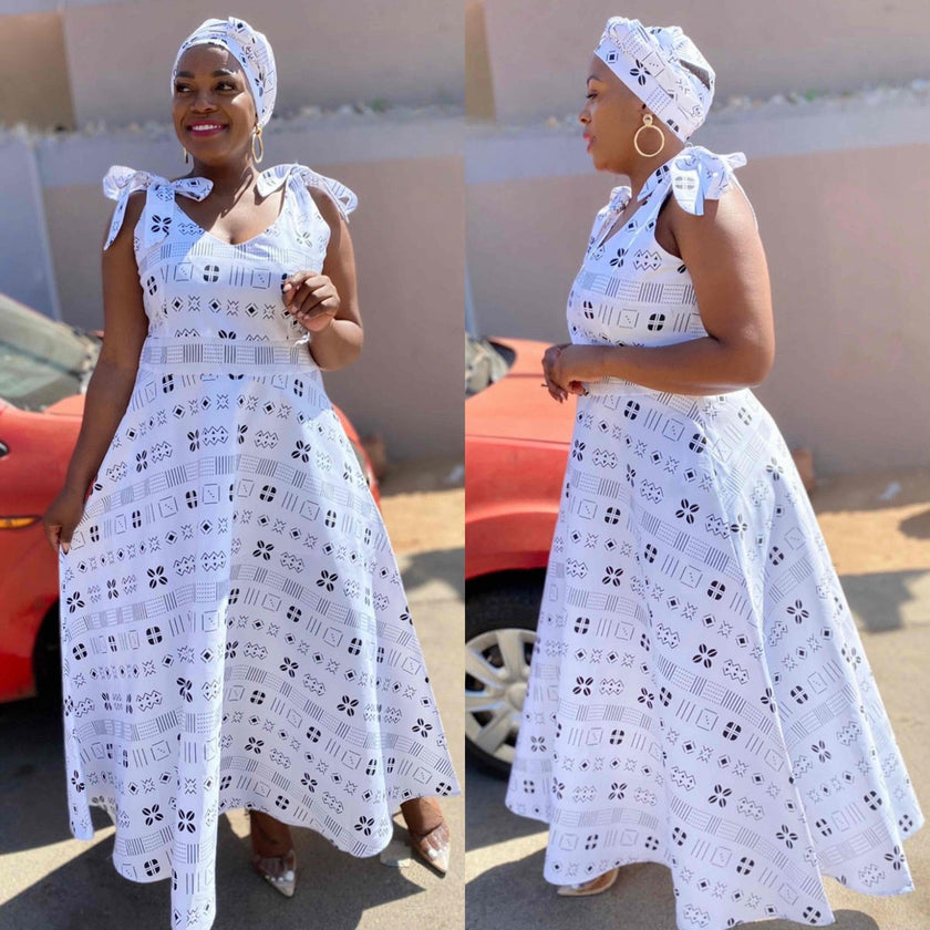 White A-line midi dress with blue patterned print and ruffle cap sleeves