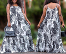 Sleeveless maxi dress with black-and-white floral print, flowy tiered skirt, thin straps