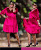 a long-sleeved, gathered-waist dress