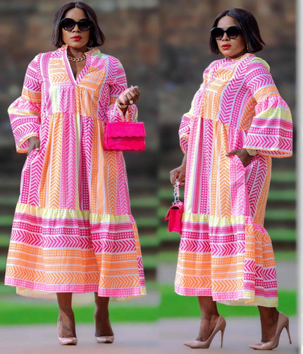 Plus size geometric midi dress with puff sleeves, V-neck, and pink-orange pattern