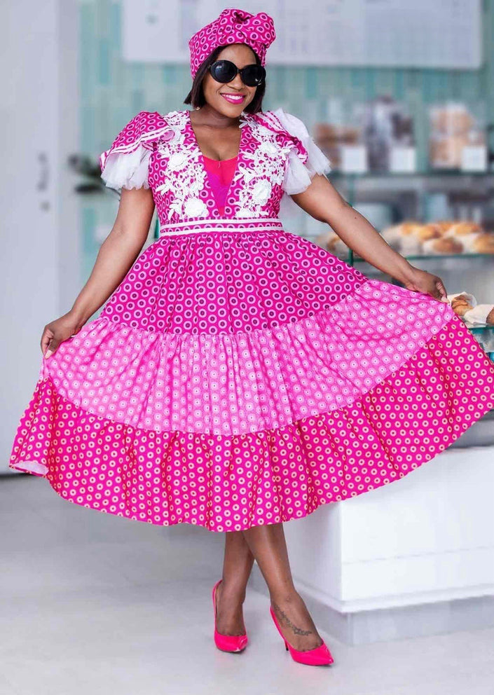 Pink midi dress with puff sleeves and white lace trim, tiered skirt
