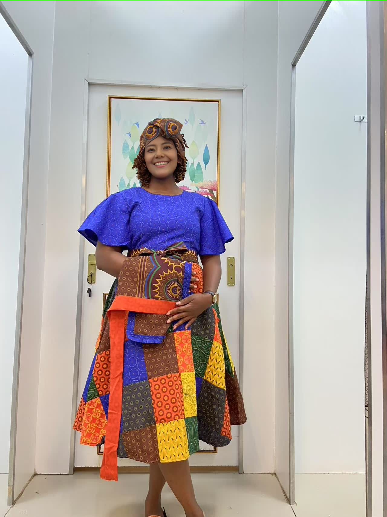 Blue puff-sleeve midi dress with multicolor patchwork skirt panels