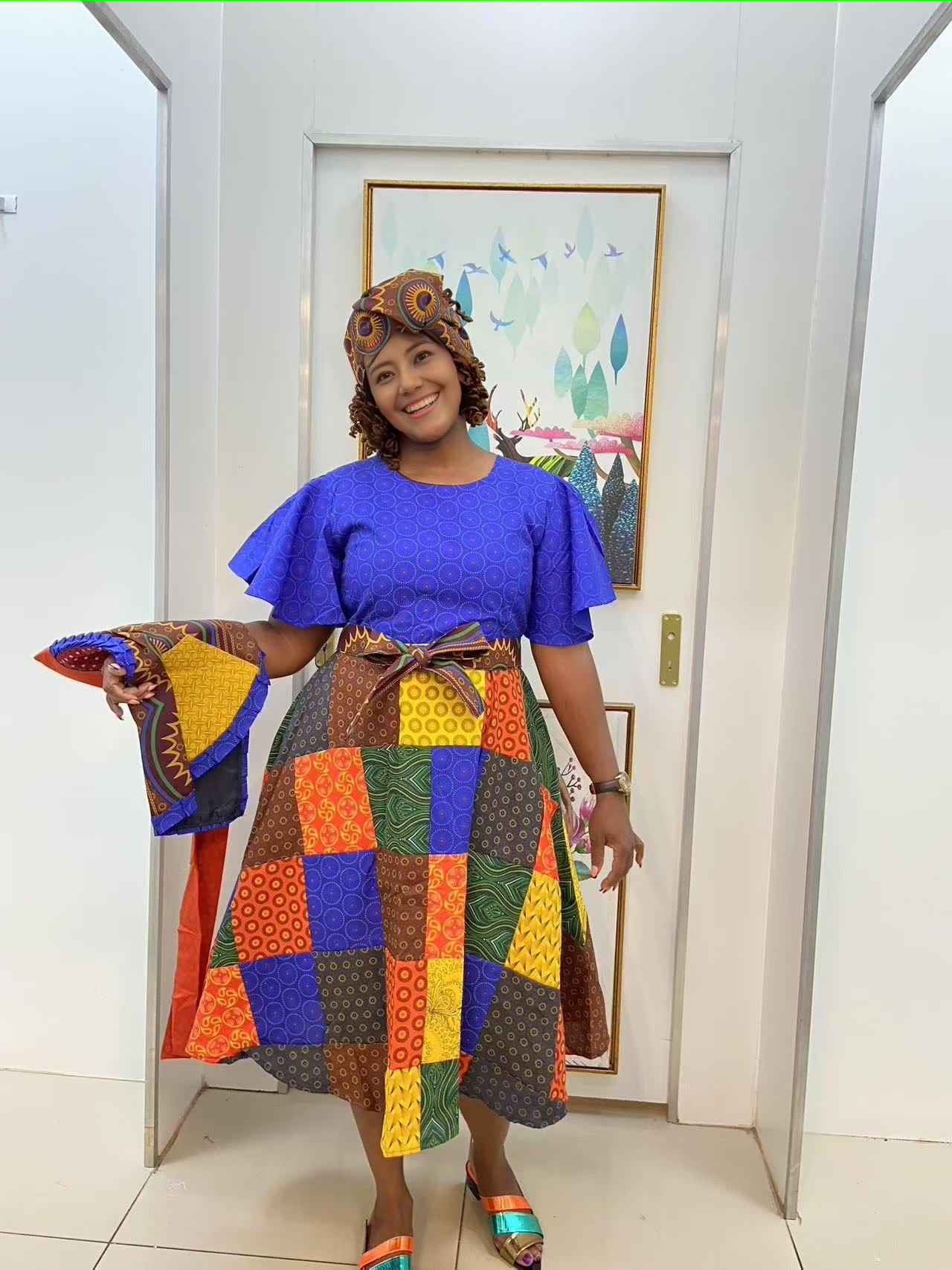 Blue puff-sleeve midi dress with patchwork panel skirt and orange fabric belt