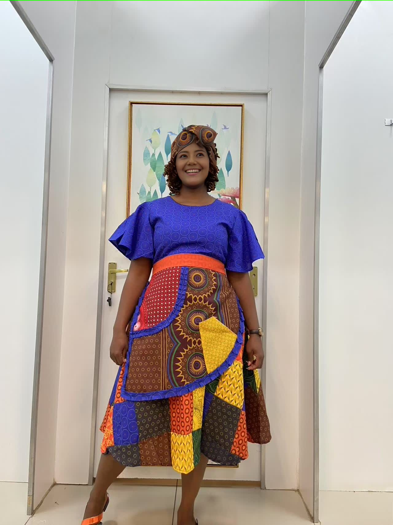 Blue puff-sleeve midi dress with colorful patchwork waistband and skirt
