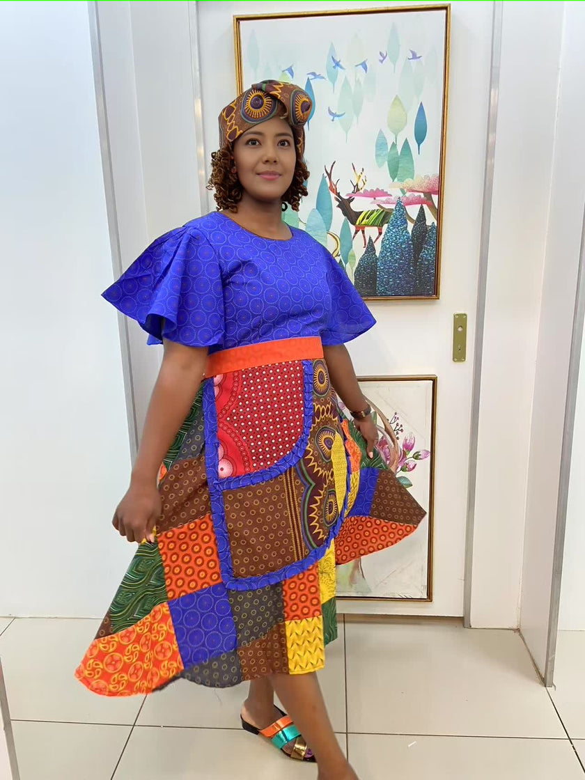 Blue puff-sleeve midi dress with patchwork skirt and wide orange waist band