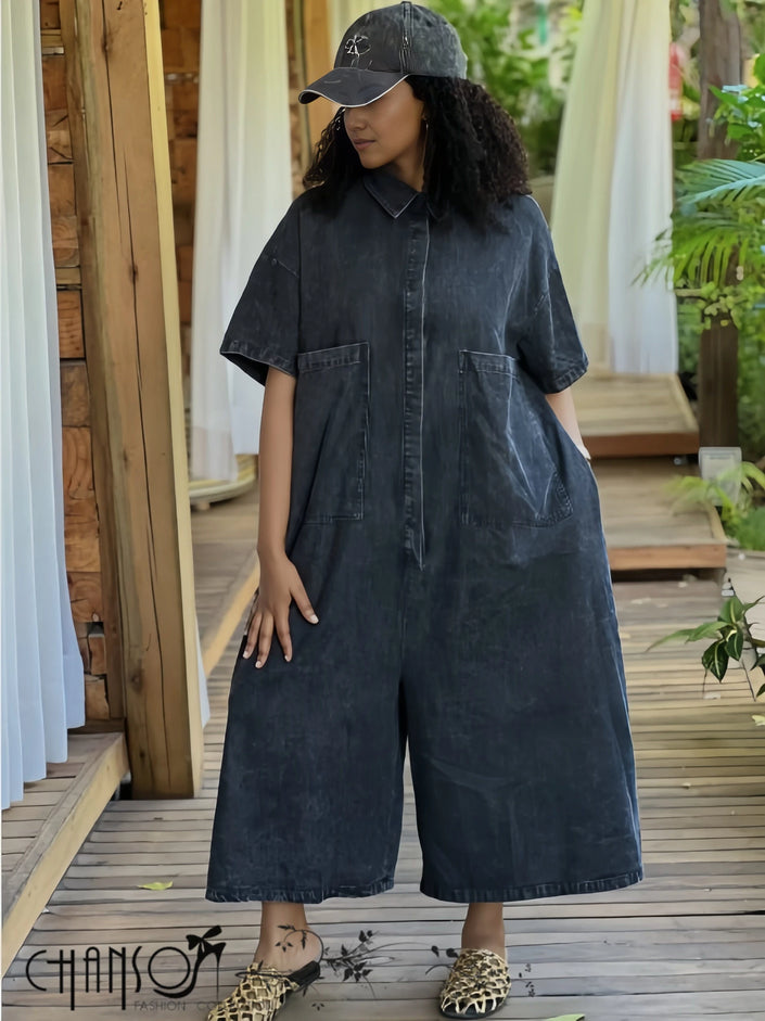 Dark denim collared jumpsuit with two front pockets and wide cropped legs