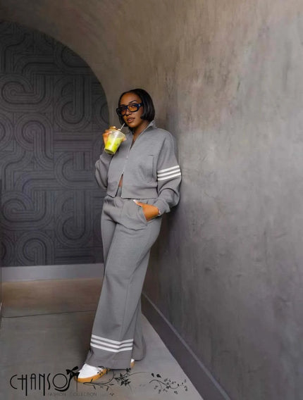 Grey zip-front jacket with striped cuffs and wide-leg pants, matching set