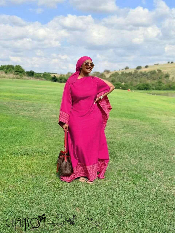 Fuchsia maxi dress with patchwork hem and long flare sleeves, side view