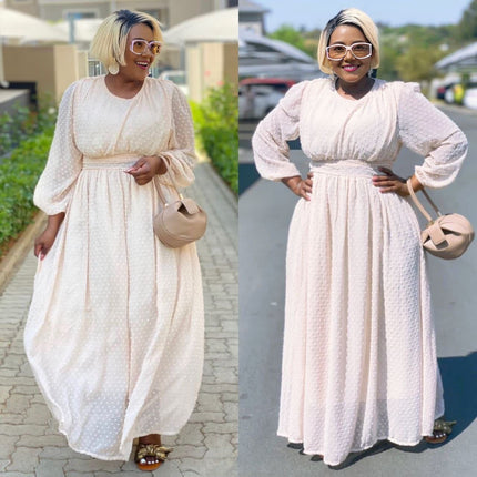 Cream maxi dress with cinched waist and puff sleeves, long swing silhouette