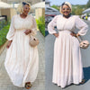 Cream maxi dress with cinched waist and puff sleeves, long swing silhouette
