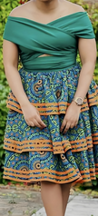 Off-shoulder patchwork dress with teal bodice, geo floral skirt, waist tie