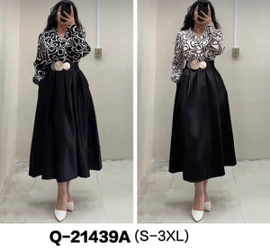 Black and white patterned long-sleeve dress with black flared skirt and waist belt