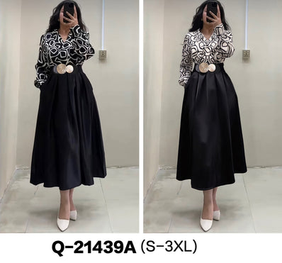 Black and white patterned long-sleeve dress with black flared skirt and waist belt