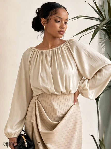 Beige gathered neckline blouse with balloon sleeves and elastic cuffs, solid fabric