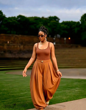 Brown harem pleated trousers with metal waist button and side pockets, relaxed fit