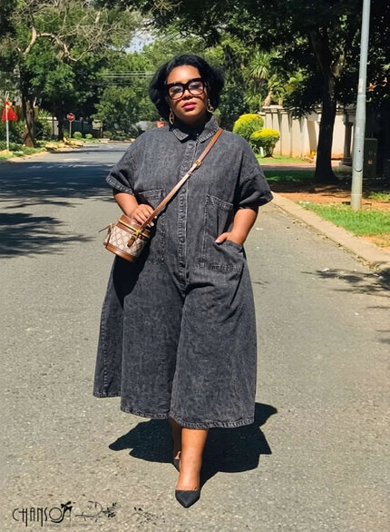 Denim jumpsuit with collared neckline, front pocket detail, relaxed wide legs