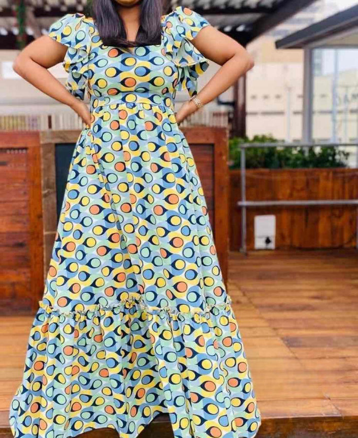 Flared maxi dress with puff sleeves, blue base and colorful circular pattern