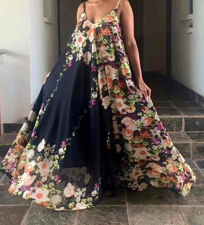 Floral maxi dress with spaghetti straps, dark base and multicolor bloom print, full skirt
