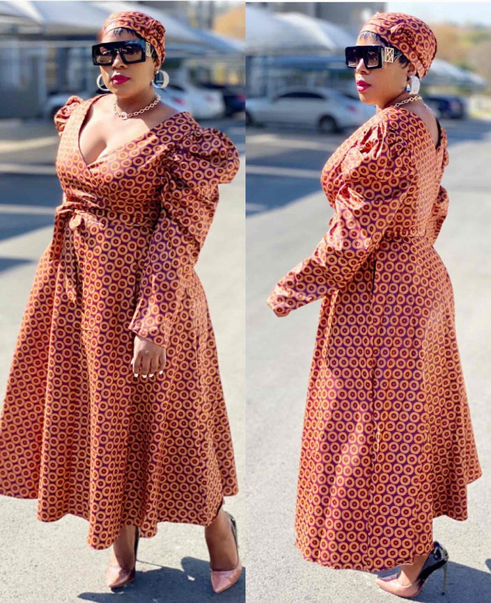 Belted V-neck puff-sleeve dress in rust patterned fabric, flared skirt