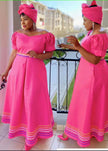 Pink puff-sleeve traditional dress with wide belt and striped hem