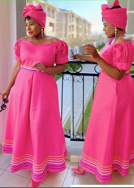 Pink puff-sleeve traditional dress with wide belt and striped hem