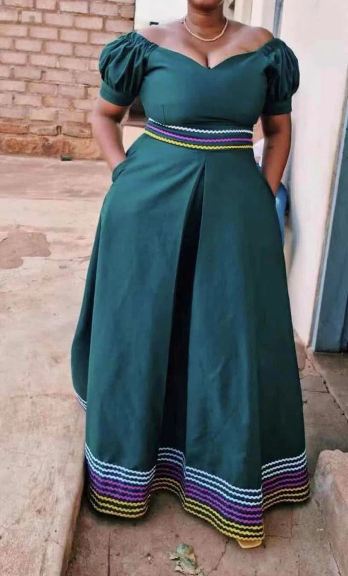 Dark teal puff-sleeve traditional dress with sash belt and striped hem