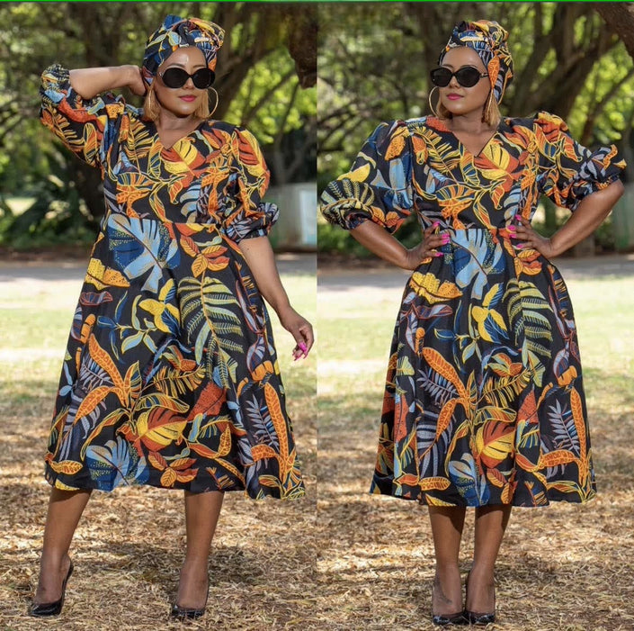 Botanical puff sleeve midi dress with navy base and orange floral print, flared skirt