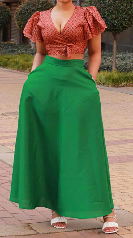 Geometric twin set: pink patterned crop top and lime-green flared maxi skirt, side view