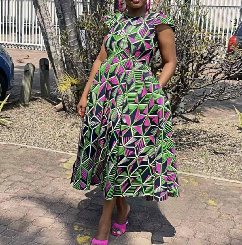 Plus size midi dress with geometric multicolor print, short sleeves, flared skirt