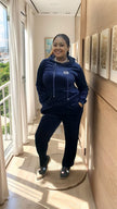 Navy zip-up hoodie and jogger pants set with front zip, drawstring hood, and cuffs