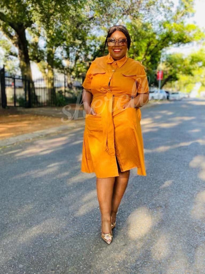Orange shirt dress with tie waist and chest pocket, short sleeves, midi length.