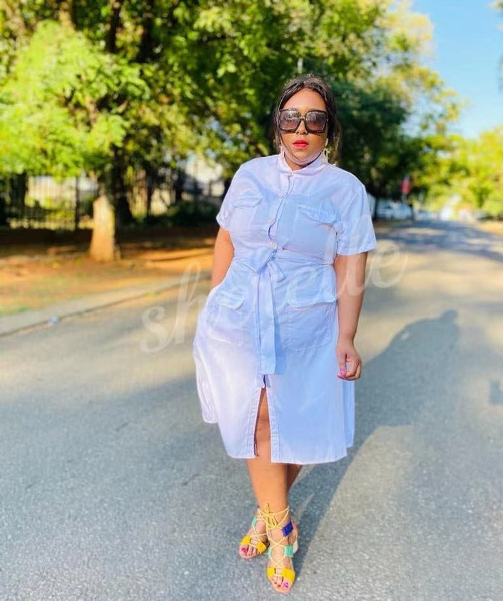 White shirt dress with tie waist and chest pocket, short sleeves, midi length.